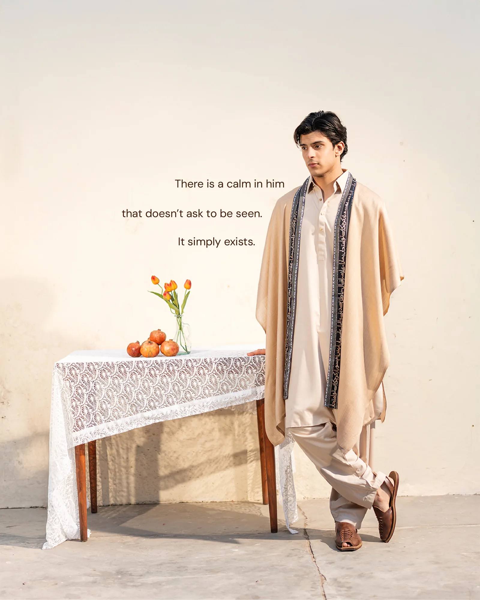 The man in cream by a lace table of pomegranates and tulips — a calm that does not ask to be seen.